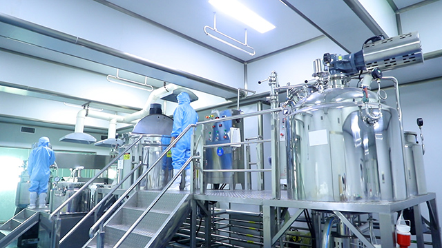 GUOCUI factory production room with cleanroom operators and stainless steel mixing equipment