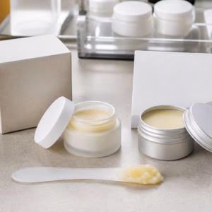 Private label nail and cuticle wax balm blank jar tin carton and wax texture sample on skincare lab bench