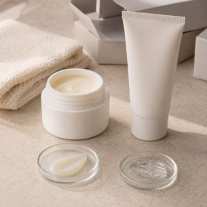 Unbranded overnight film cream jar and tube samples with translucent texture dishes on a factory sample table